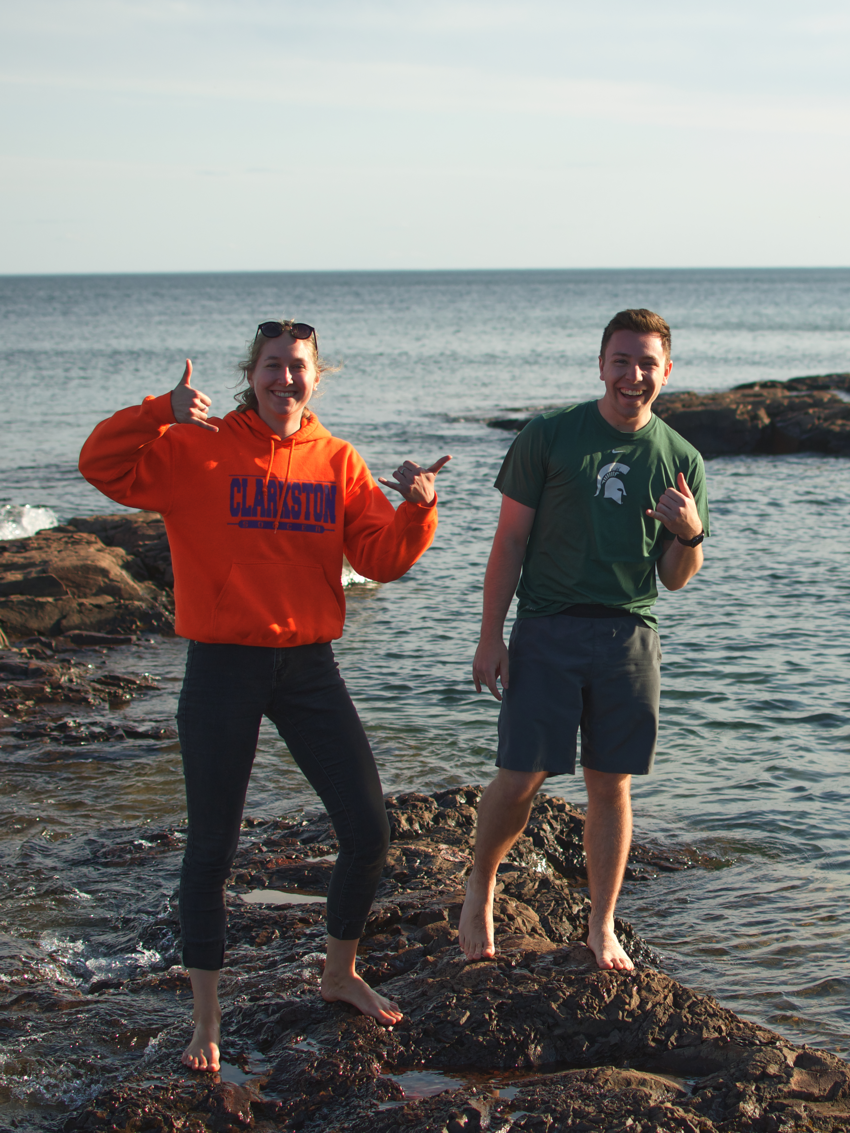 Picture of Andrew and Jess standing on rocks in Lake Superior